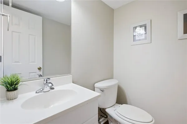 a bathroom with a sink a toilet and mirror