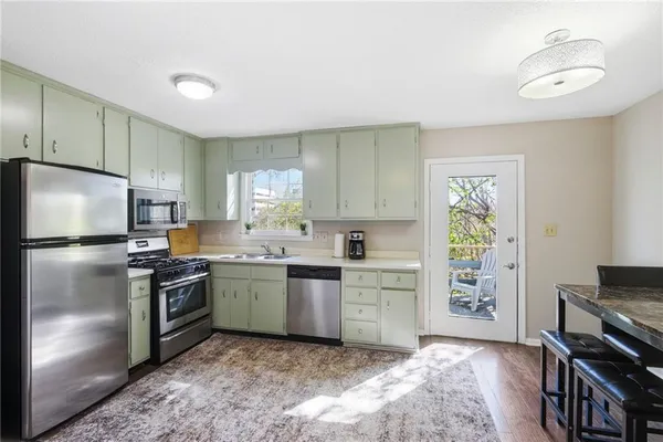 a kitchen with a stove a sink and a refrigerator
