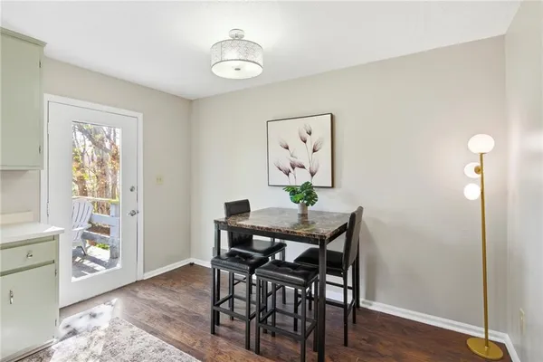 a view of a dining room with furniture and wooden floor