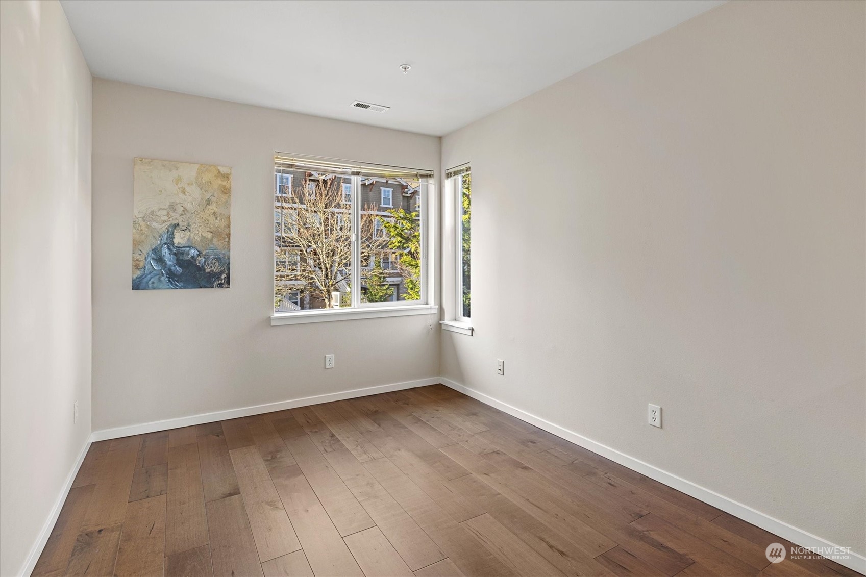 103 Sky Ridge Road Northwest Issaquah, WA 98027 - Photo 26 of 37 an empty room with wooden floor and windows