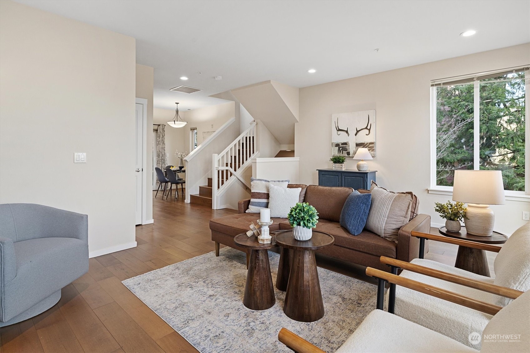 103 Sky Ridge Road Northwest Issaquah, WA 98027 - Photo 7 of 37 a living room with furniture and wooden floor