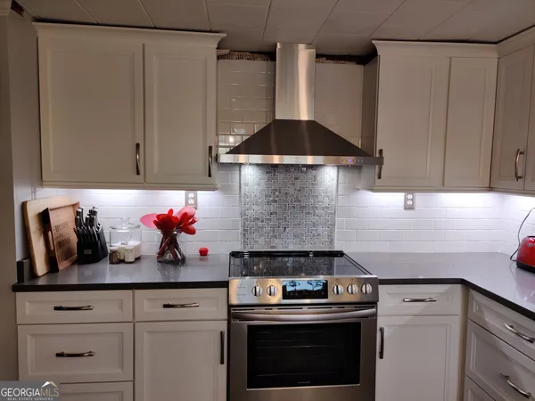 a kitchen with a stove and cabinets