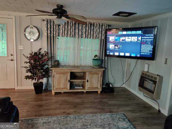 a living room with fireplace furniture and a flat screen tv