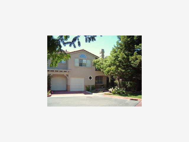 a picture of a bench in front of a house