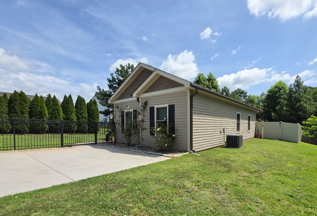 3 Cringle Lane Anderson, SC 29625 - Photo 20 of 26 A neatly maintained lawn surrounds this residence, featuring a secure fence and paved driveway.