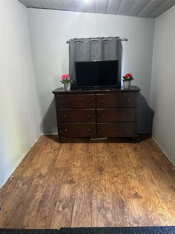 a room with dresser and flat screen tv