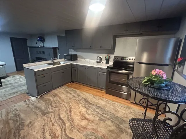 a kitchen with granite countertop stainless steel appliances and wooden cabinets