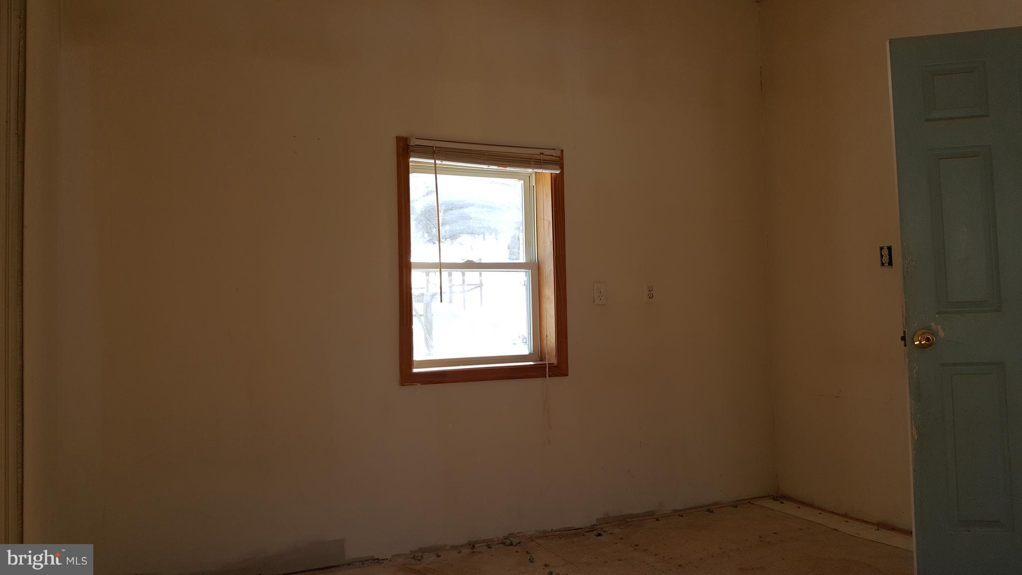 24581 Hells Delight Road Smithsburg, MD 21783 - Photo 11 of 22 an empty room with a window