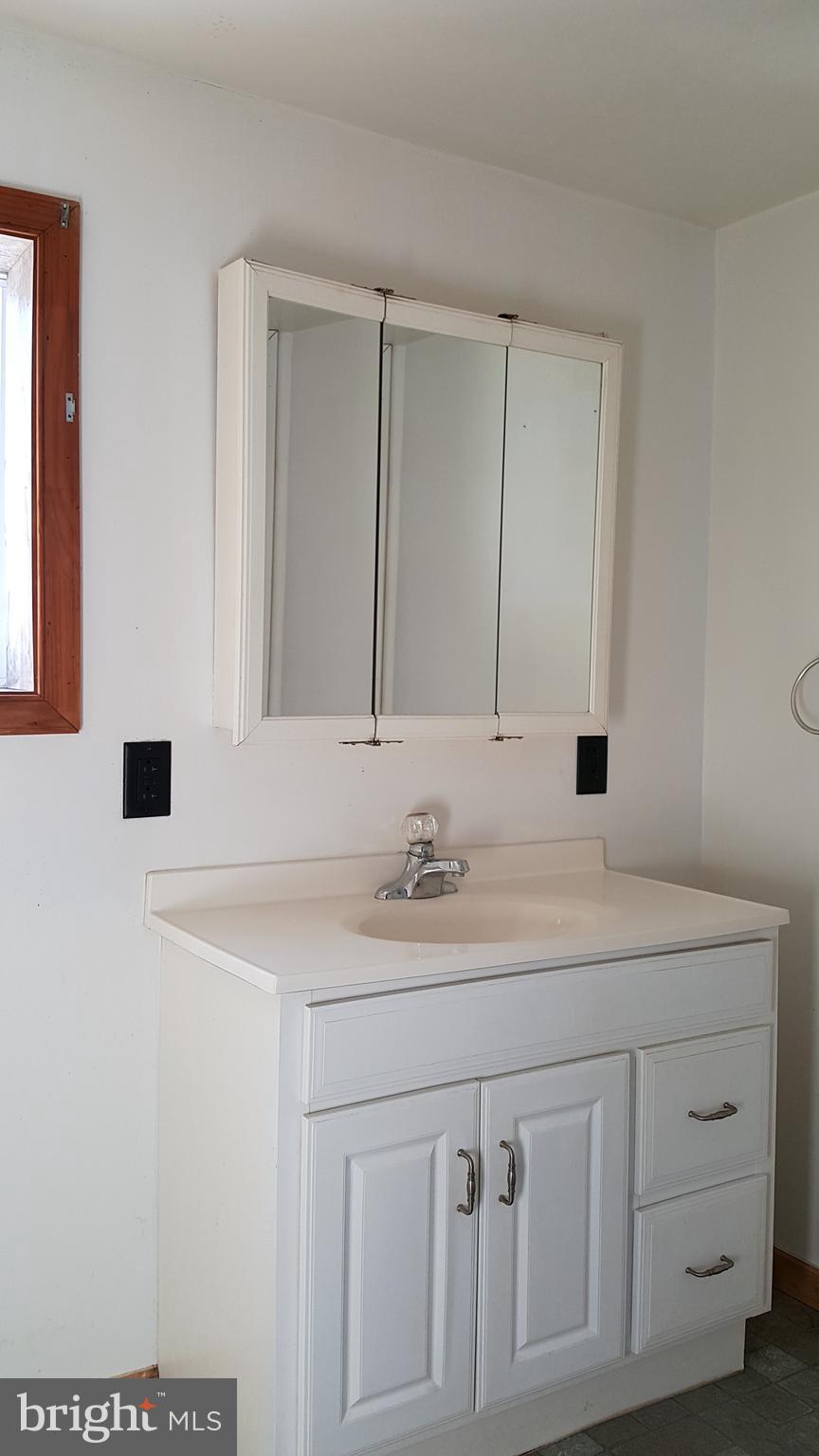 24581 Hells Delight Road Smithsburg, MD 21783 - Photo 20 of 22 a bathroom with a sink and a mirror