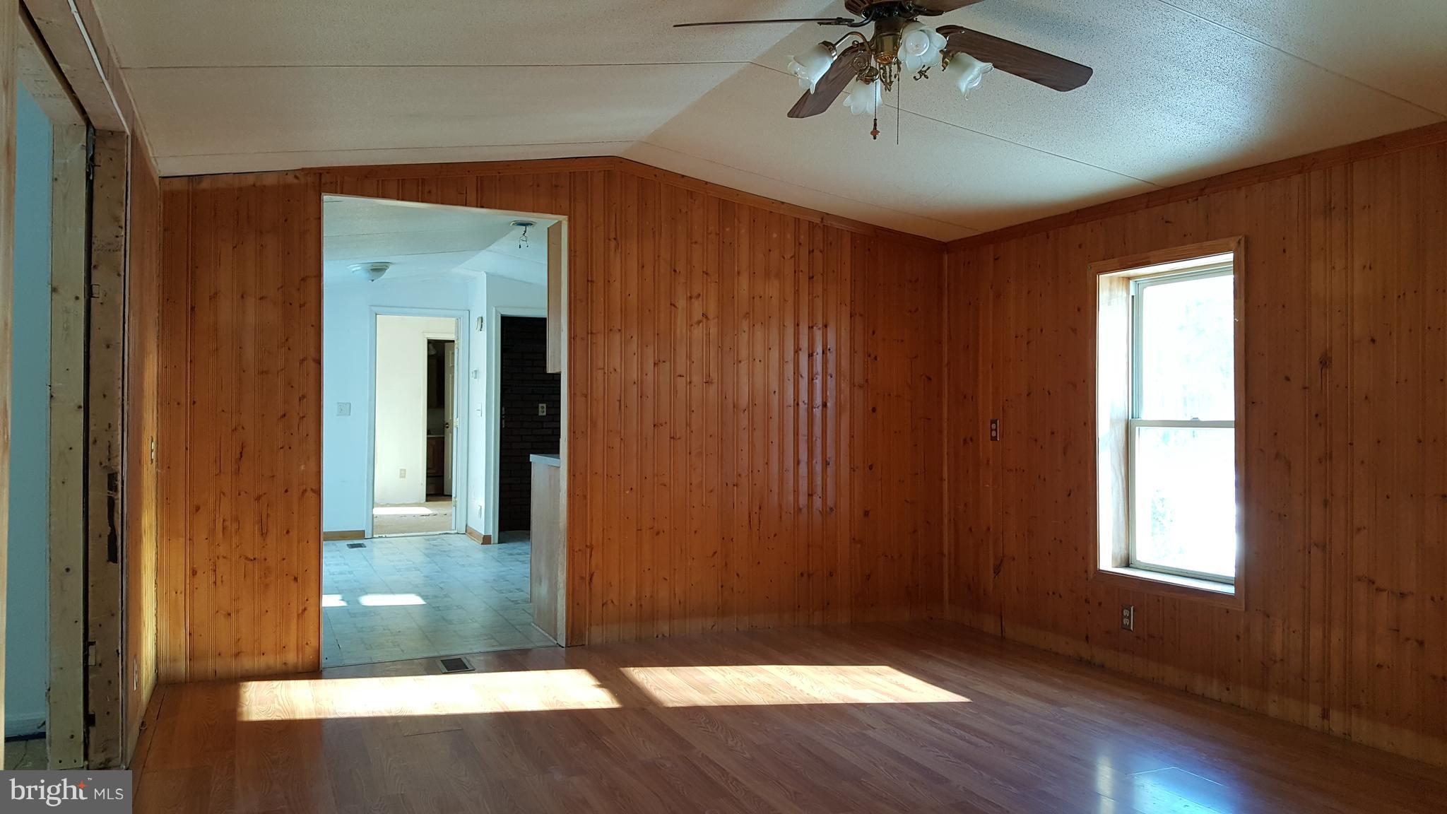 24581 Hells Delight Road Smithsburg, MD 21783 - Photo 4 of 22 wooden floor in an empty room with a window