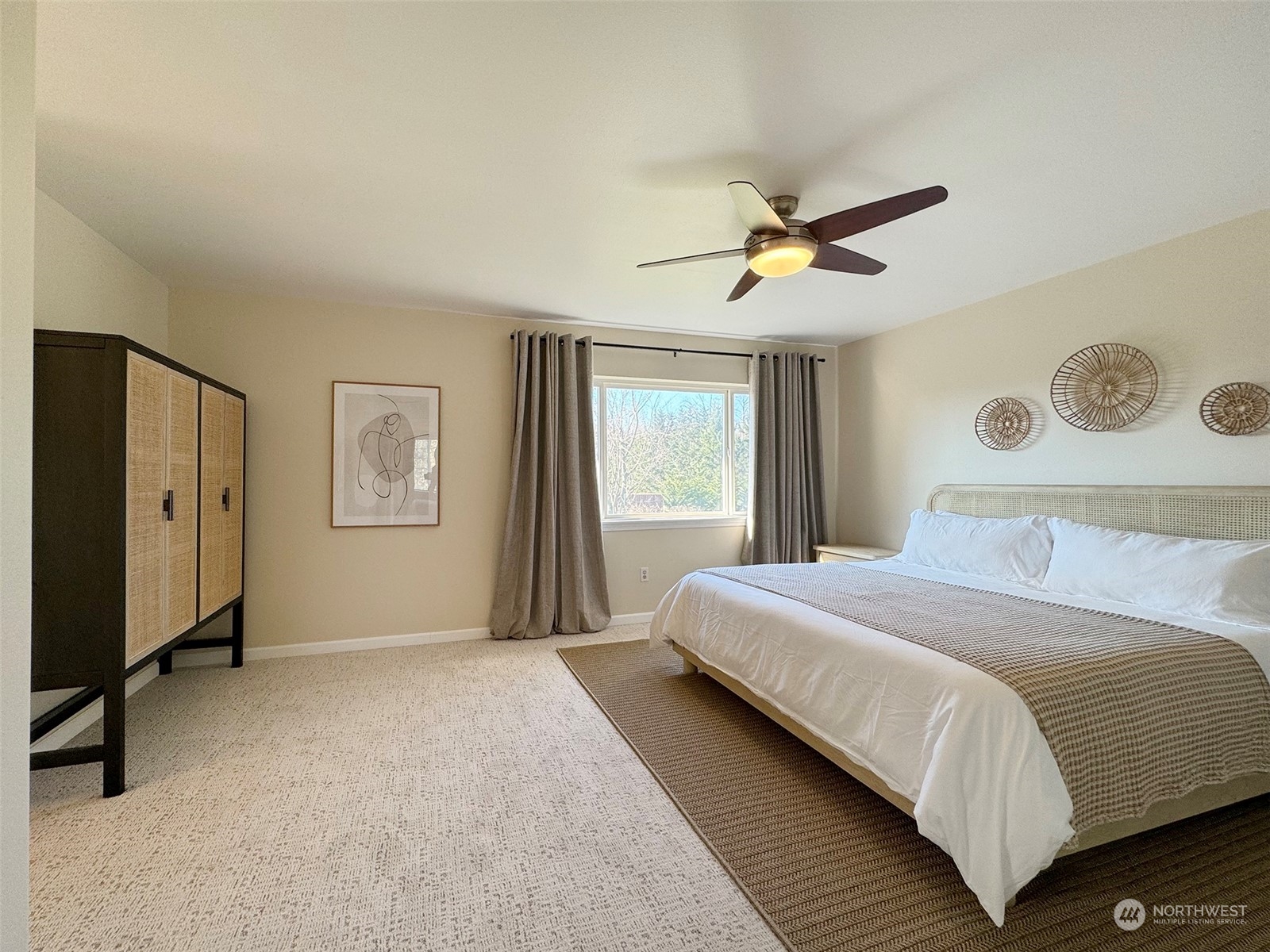 293 Griffith Farm Road Sequim, WA 98382 - Photo 24 of 40 a spacious bedroom with a bed and a window