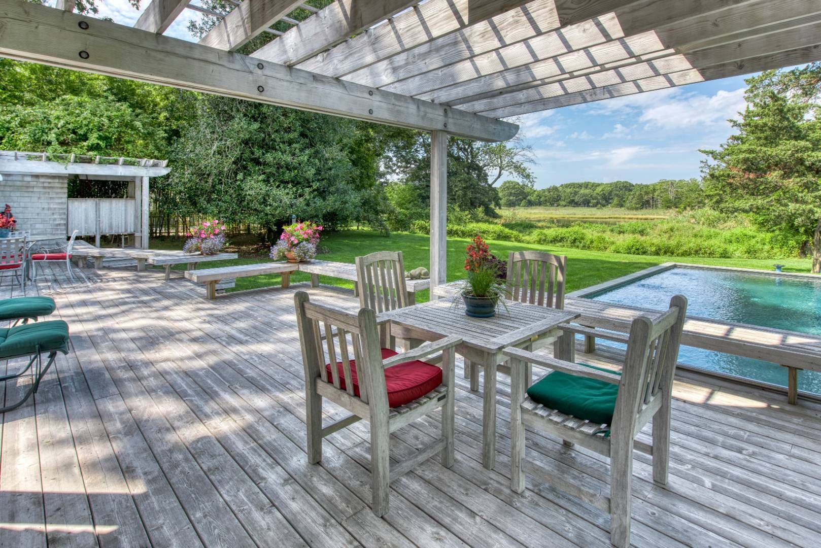 69 Fresh Pond Road Sag Harbor, NY 11963 - Photo 7 of 13 a view of a patio with a table chairs and a patio