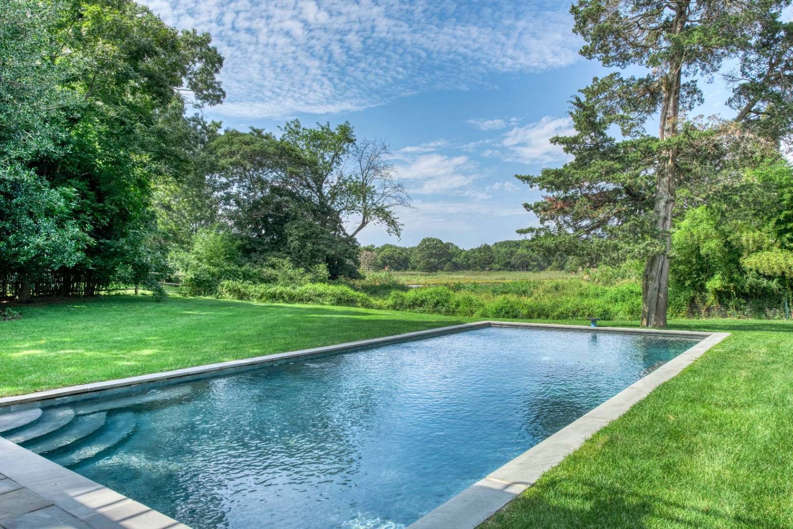 69 Fresh Pond Road Sag Harbor, NY 11963 - Photo 8 of 13 a view of a backyard with green space