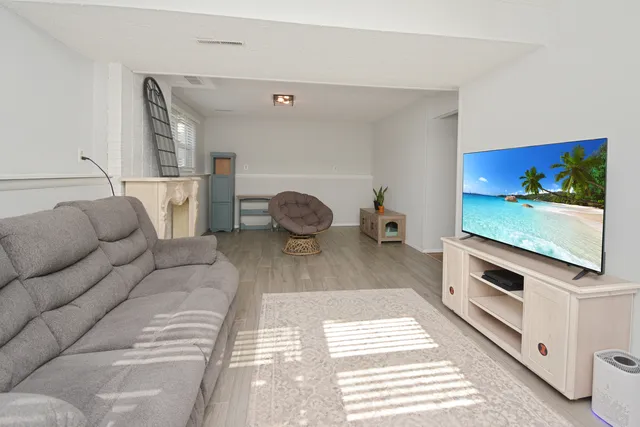 a large bed sitting in a bedroom next to a window