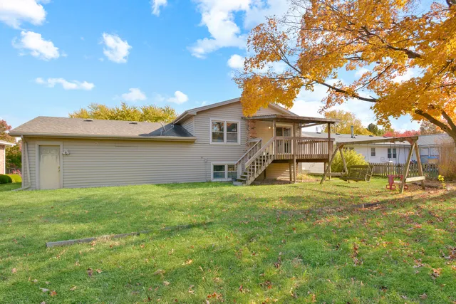 a view of a house with a backyard and a tree