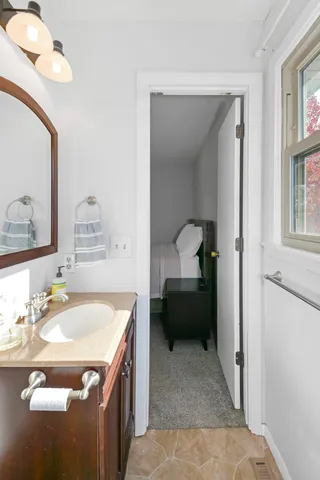 a bathroom with a sink toilet and mirror