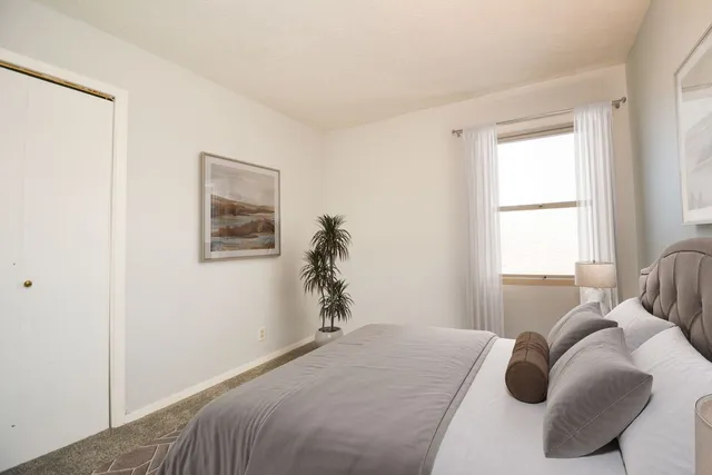 a bedroom with a bed and window