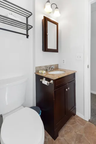 a bathroom with a sink vanity and a mirror