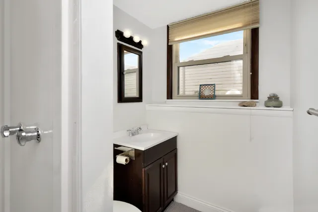 a living room with furniture a rug and a window