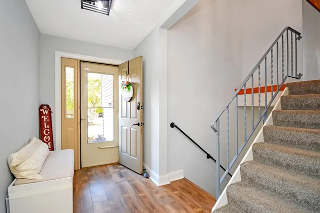 a dining room with furniture and wooden floor