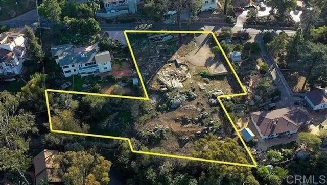 an aerial view of residential house with outdoor space and trees all around