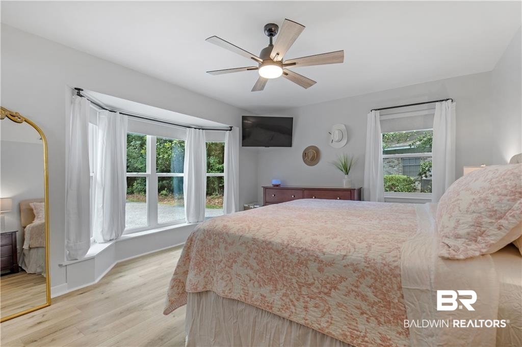 1624 Apex Drive Mobile, AL 36693 - Photo 22 of 29 Bedroom featuring light hardwood / wood-style flooring, multiple windows, and ceiling fan