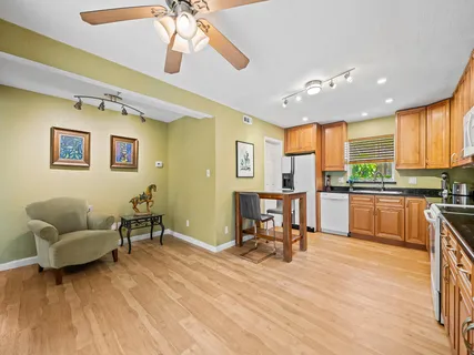 a living room with furniture and kitchen view