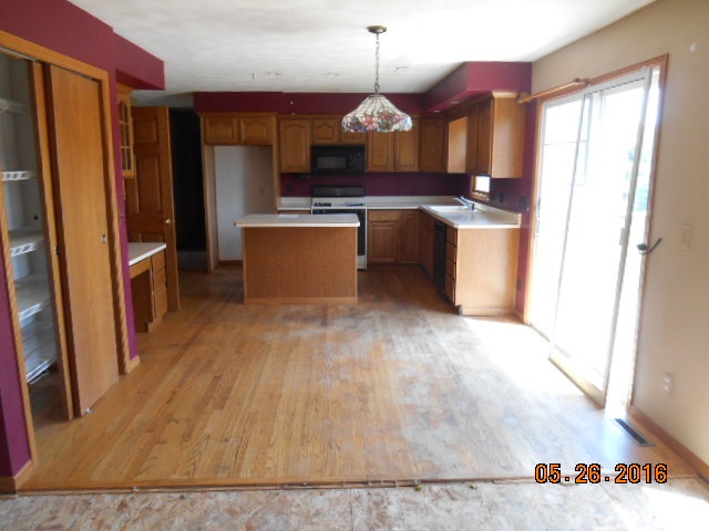 938 Lake Summerset Road Davis, IL 61019 - Photo 6 of 25 a kitchen with stainless steel appliances granite countertop a sink a stove and a refrigerator
