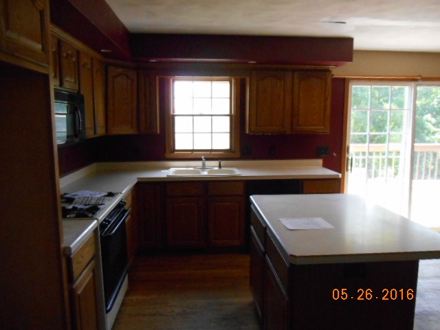 938 Lake Summerset Road Davis, IL 61019 - Photo 7 of 25 a kitchen with a stove a sink and a microwave