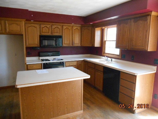 938 Lake Summerset Road Davis, IL 61019 - Photo 8 of 25 a kitchen with stainless steel appliances granite countertop a stove a sink and a microwave