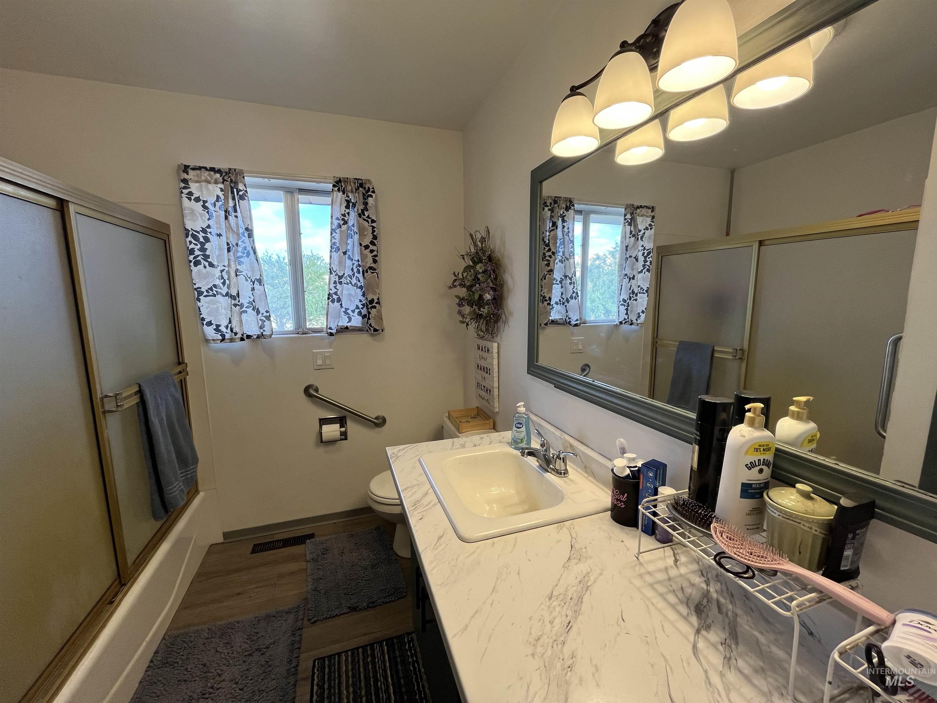 1048 Reynolds Road Princeton, ID 83857 - Photo 12 of 41 Main floor Bathroom featuring enclosed tub / shower combo, healthy amount of natural light, vanity,