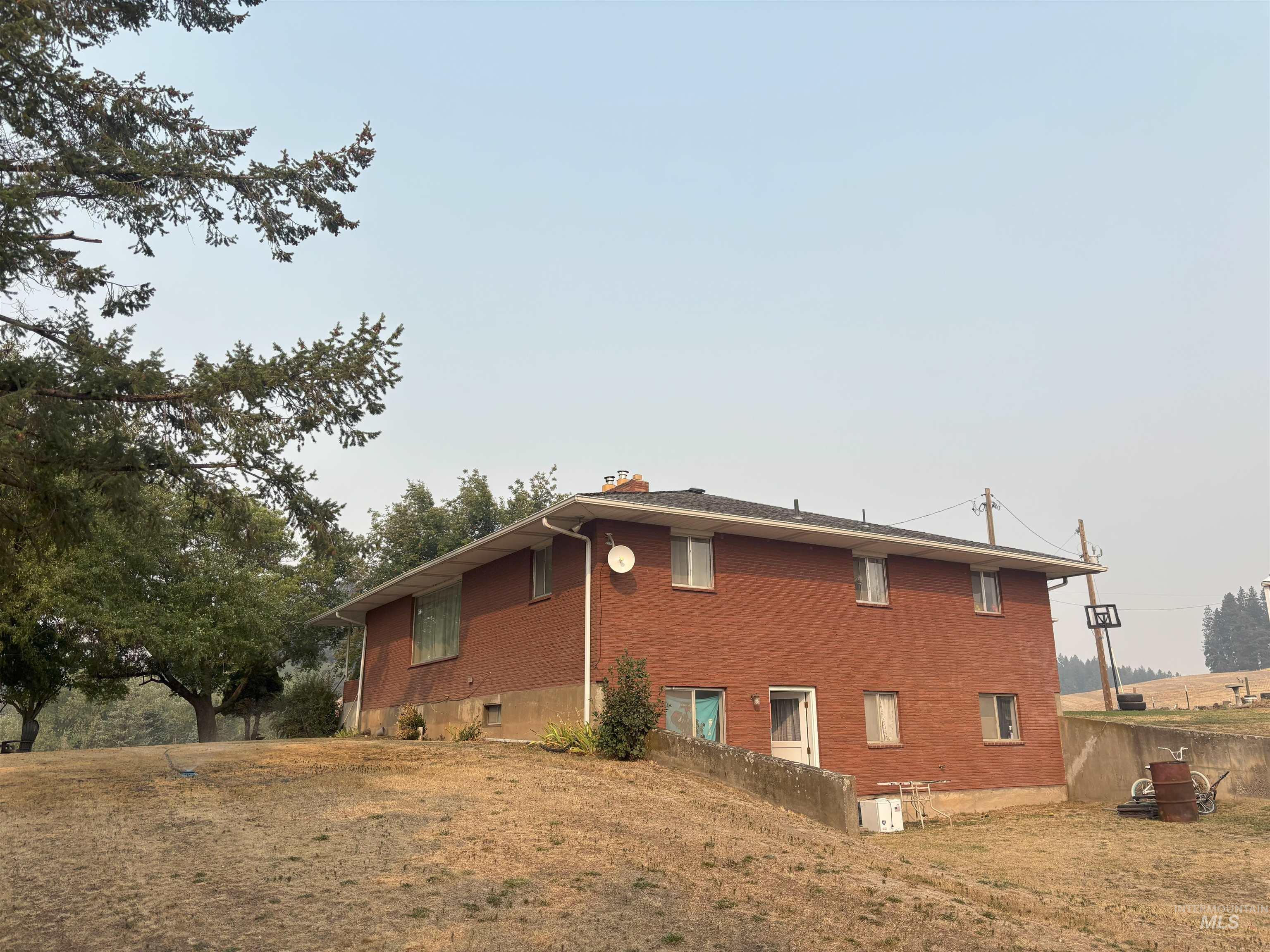 1048 Reynolds Road Princeton, ID 83857 - Photo 27 of 41 View of home's exterior featuring a chimney and brick siding