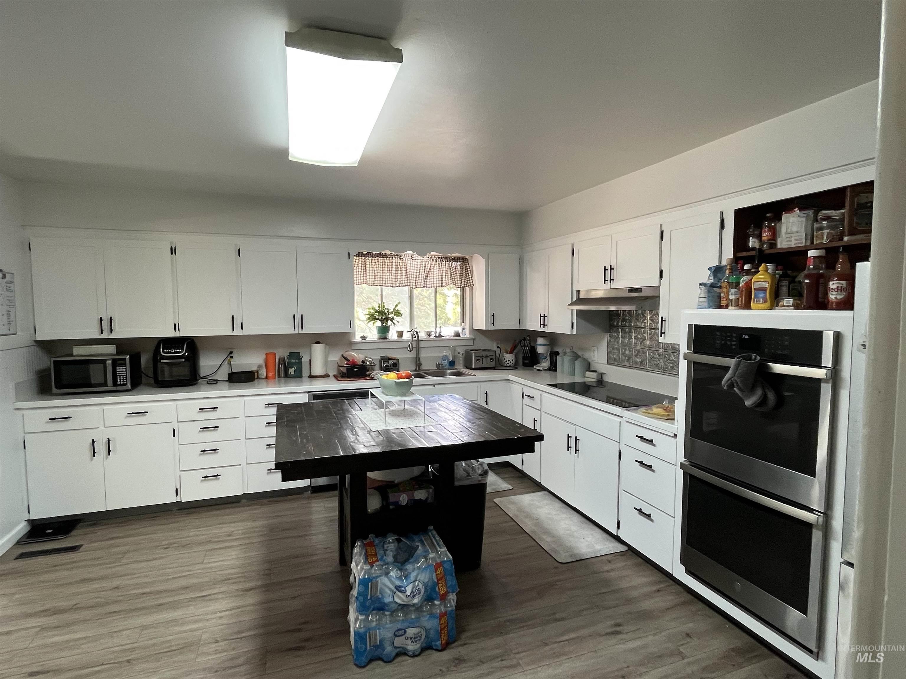 1048 Reynolds Road Princeton, ID 83857 - Photo 9 of 41 Kitchen with double ovens and a glass cooking top