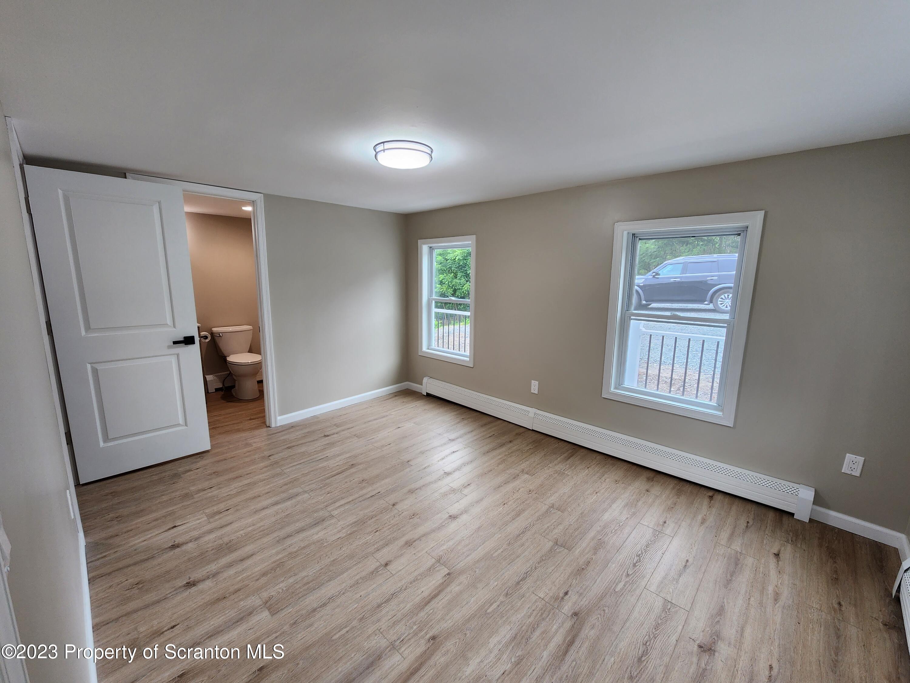 257 Maple Drive Dalton, PA 18414 - Photo 13 of 31 a view of an empty room with a window and wooden floor