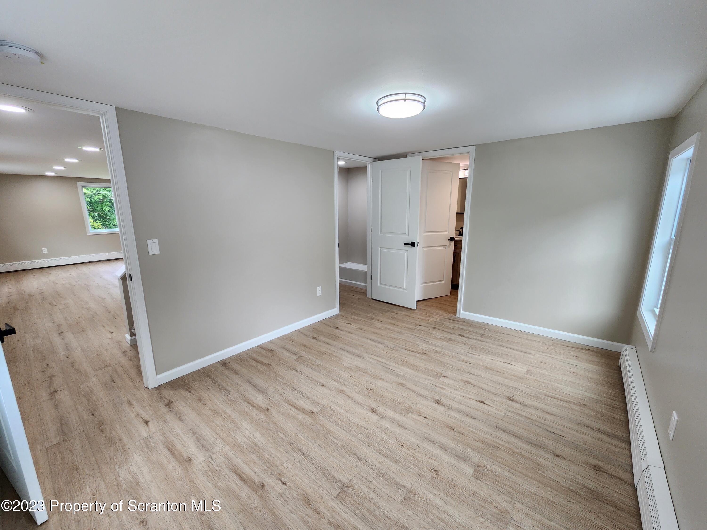 257 Maple Drive Dalton, PA 18414 - Photo 15 of 31 wooden floor in an empty room with a window