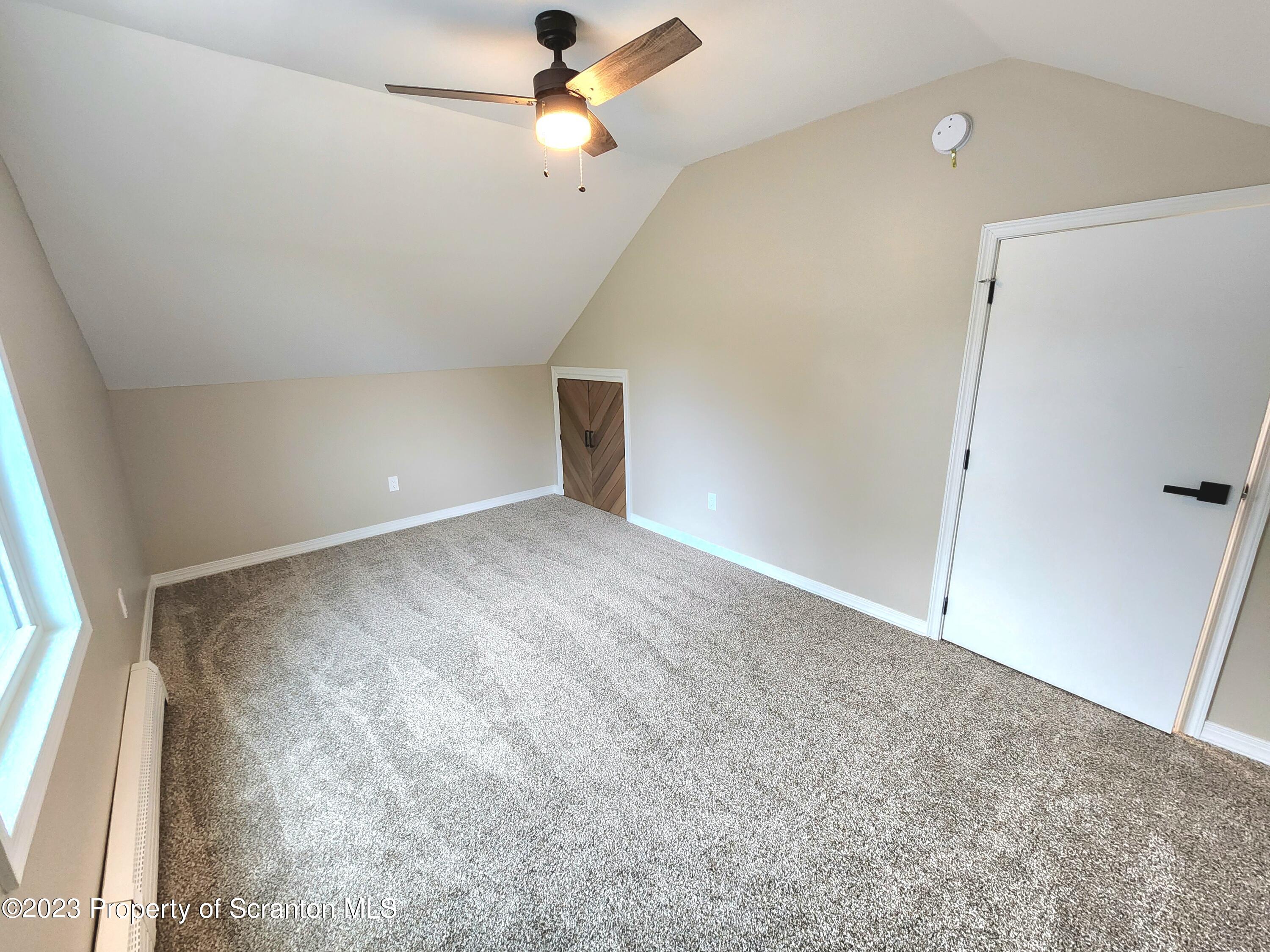 257 Maple Drive Dalton, PA 18414 - Photo 17 of 31 en empty room with ceiling fan and window