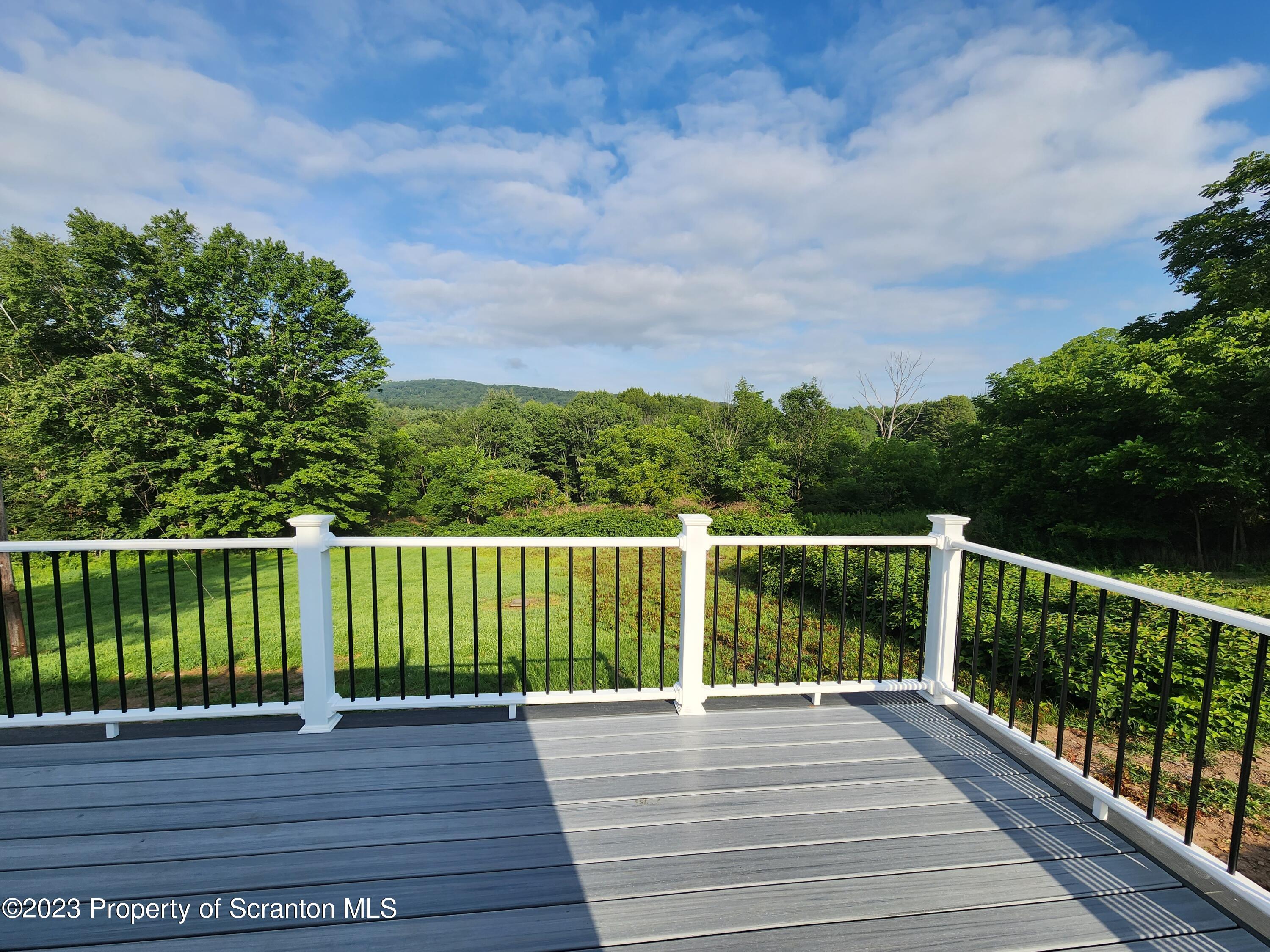 257 Maple Drive Dalton, PA 18414 - Photo 26 of 31 a view of balcony with wooden floor and fence