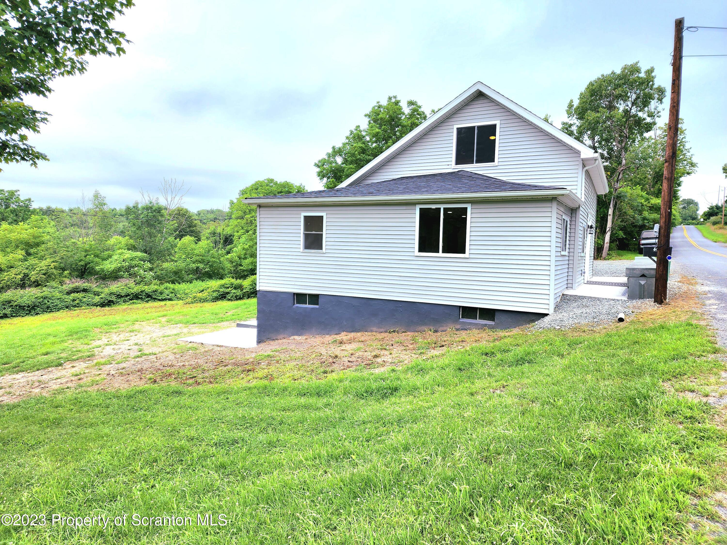 257 Maple Drive Dalton, PA 18414 - Photo 31 of 31 a front view of house with yard and green space