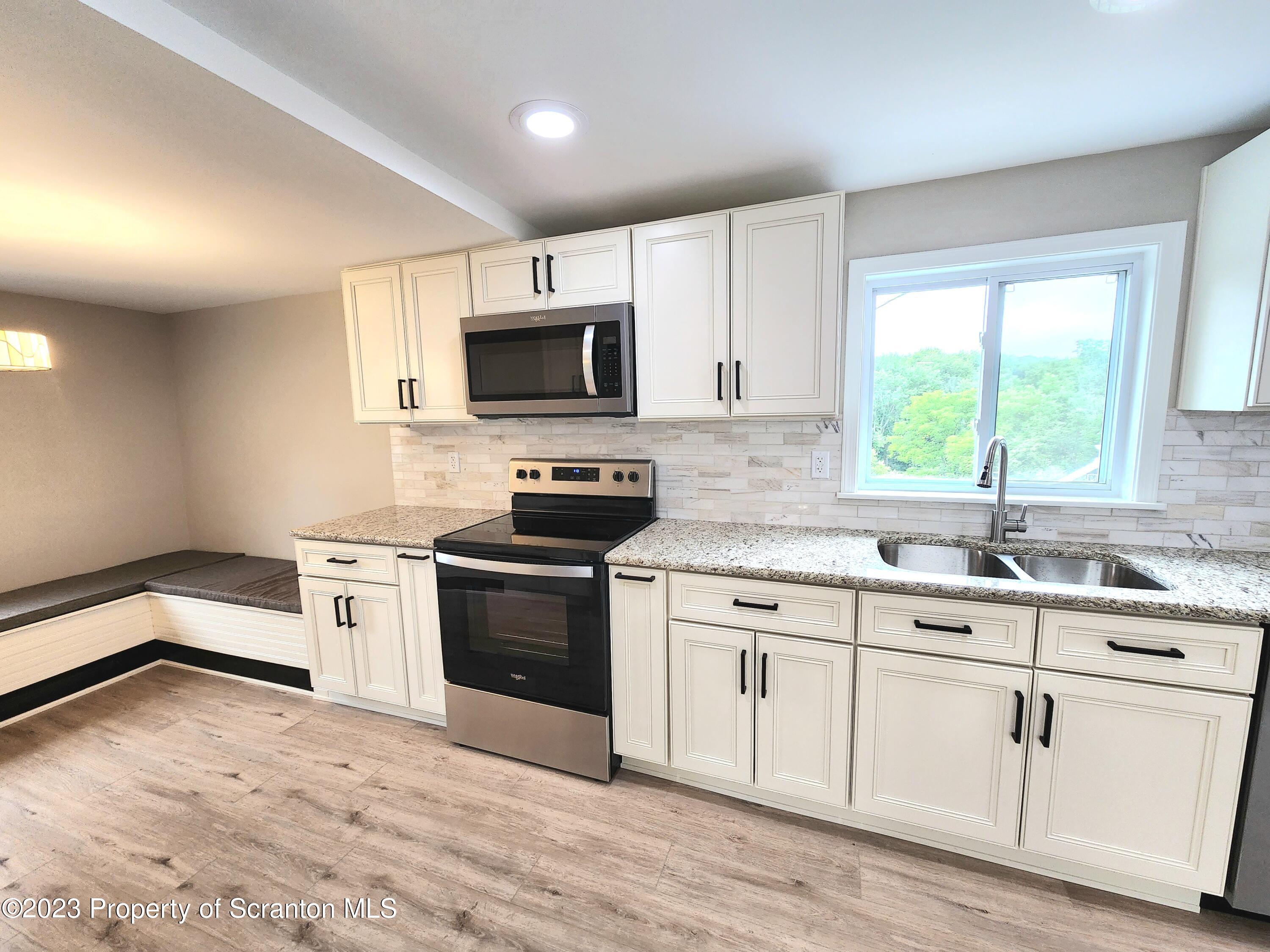 257 Maple Drive Dalton, PA 18414 - Photo 7 of 31 a kitchen with granite countertop appliances cabinets and a sink