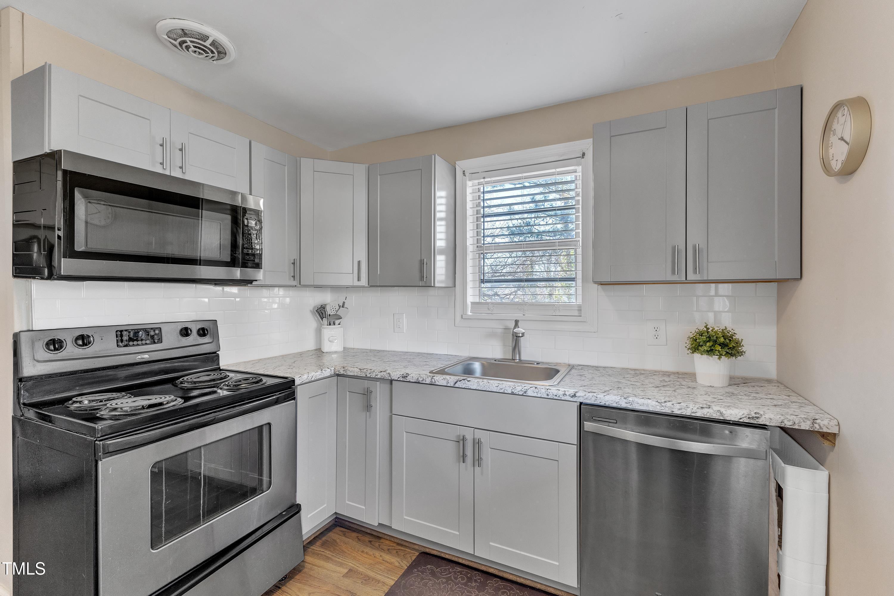 602 Quarry Street Raleigh, NC 27601 - Photo 11 of 49 a kitchen with granite countertop a sink cabinets and stainless steel appliances