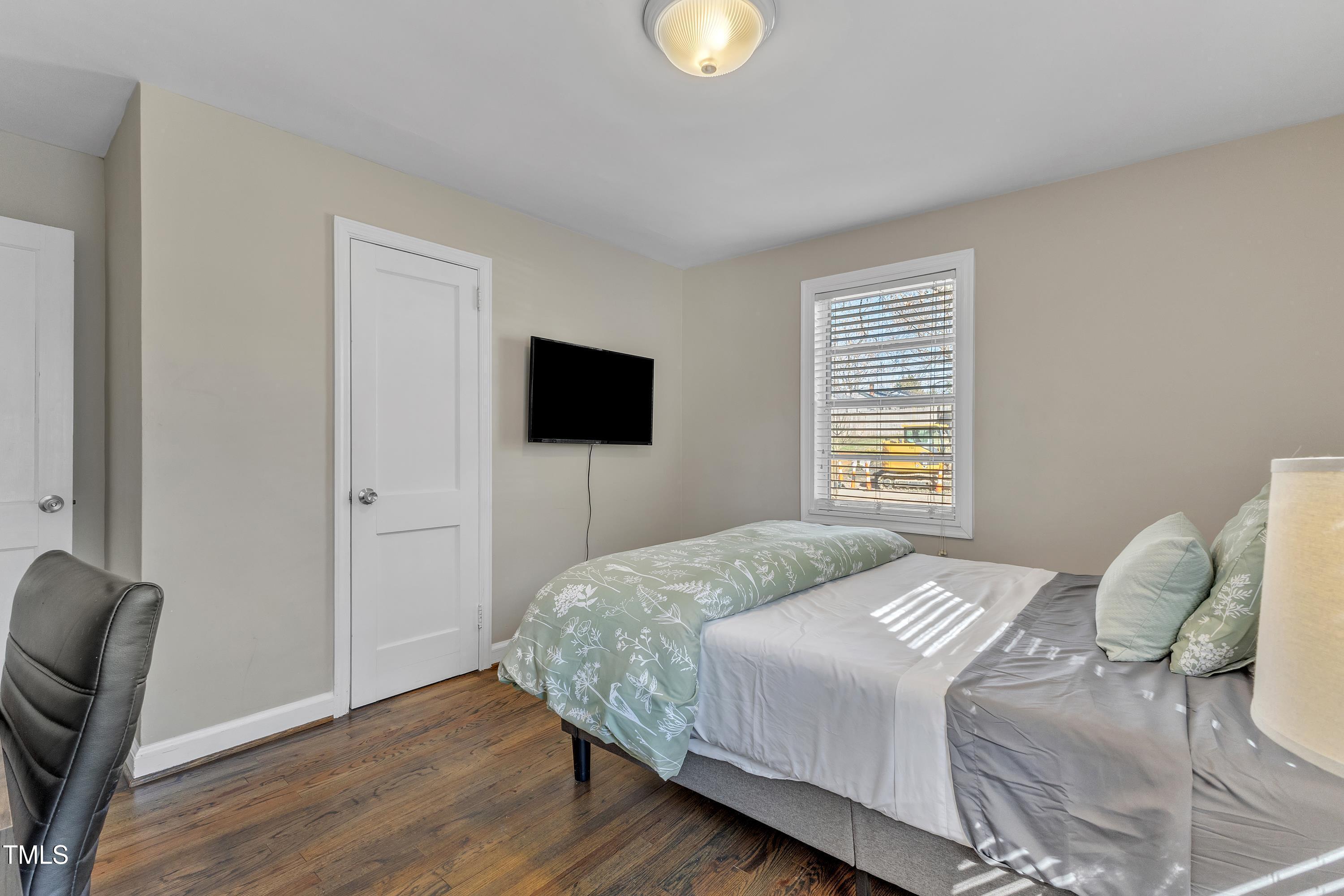 602 Quarry Street Raleigh, NC 27601 - Photo 18 of 49 a bedroom with a bed and a television