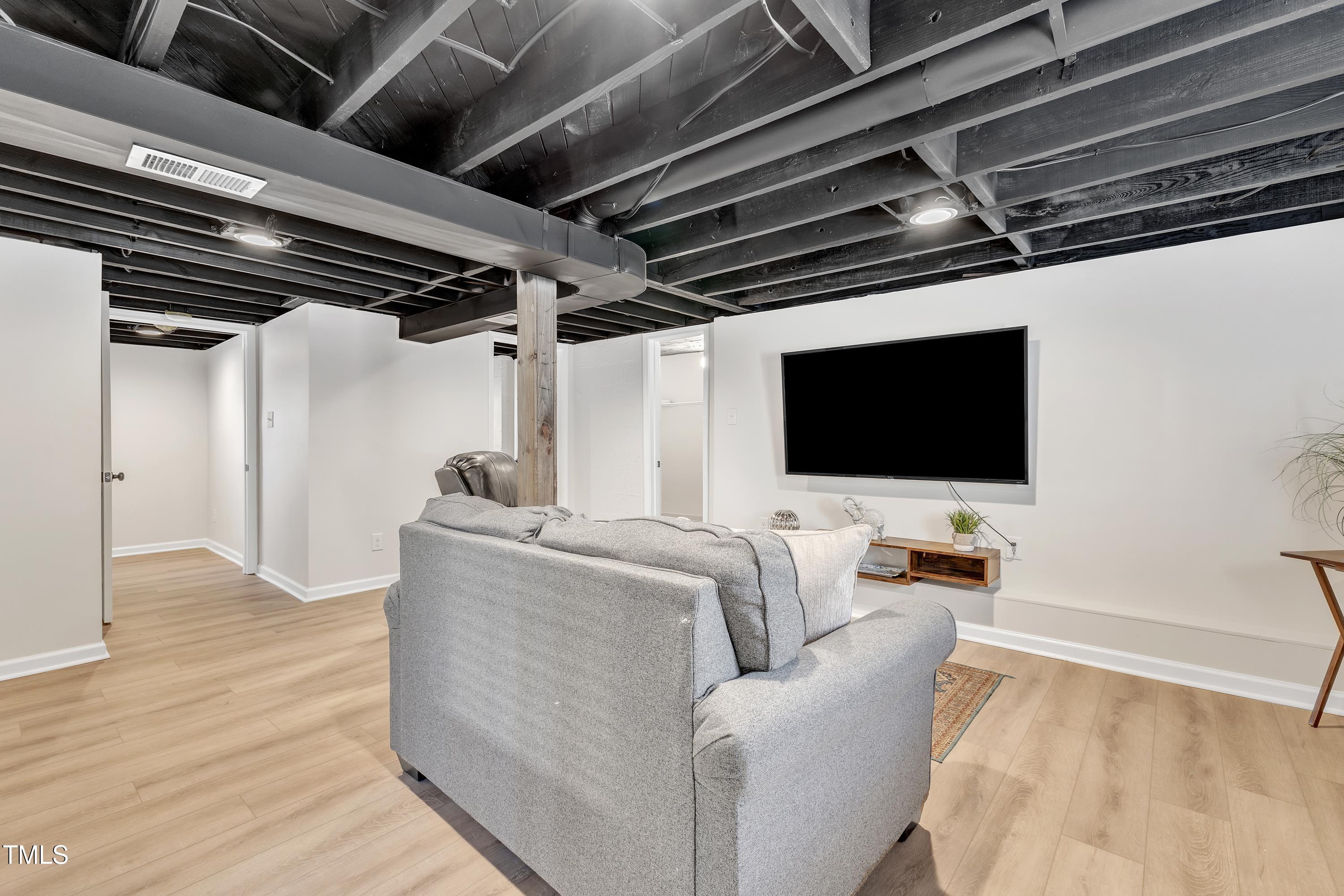 602 Quarry Street Raleigh, NC 27601 - Photo 26 of 49 a living room with furniture and a flat screen tv