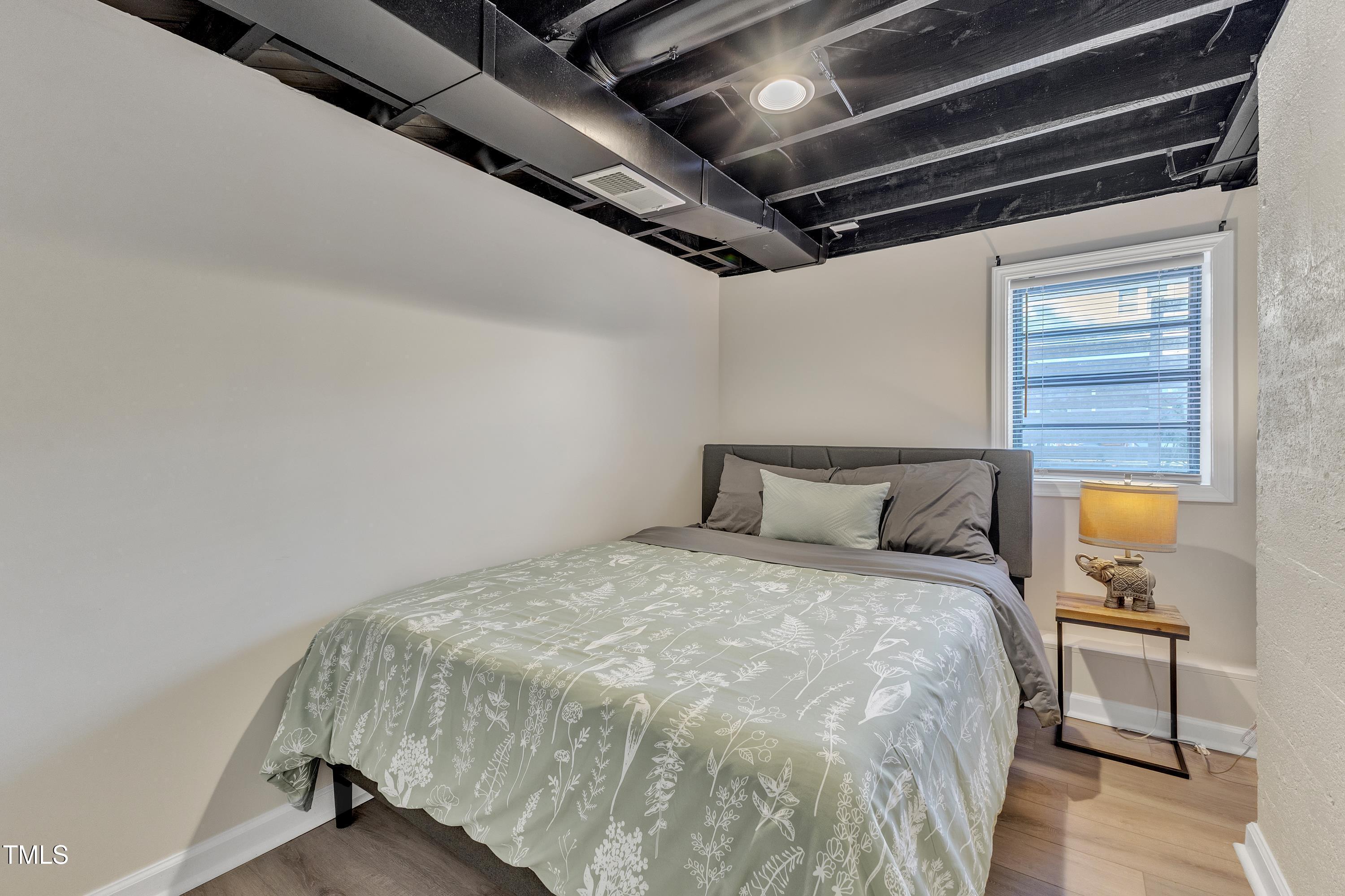 602 Quarry Street Raleigh, NC 27601 - Photo 28 of 49 a large bed sitting in a bedroom next to a window