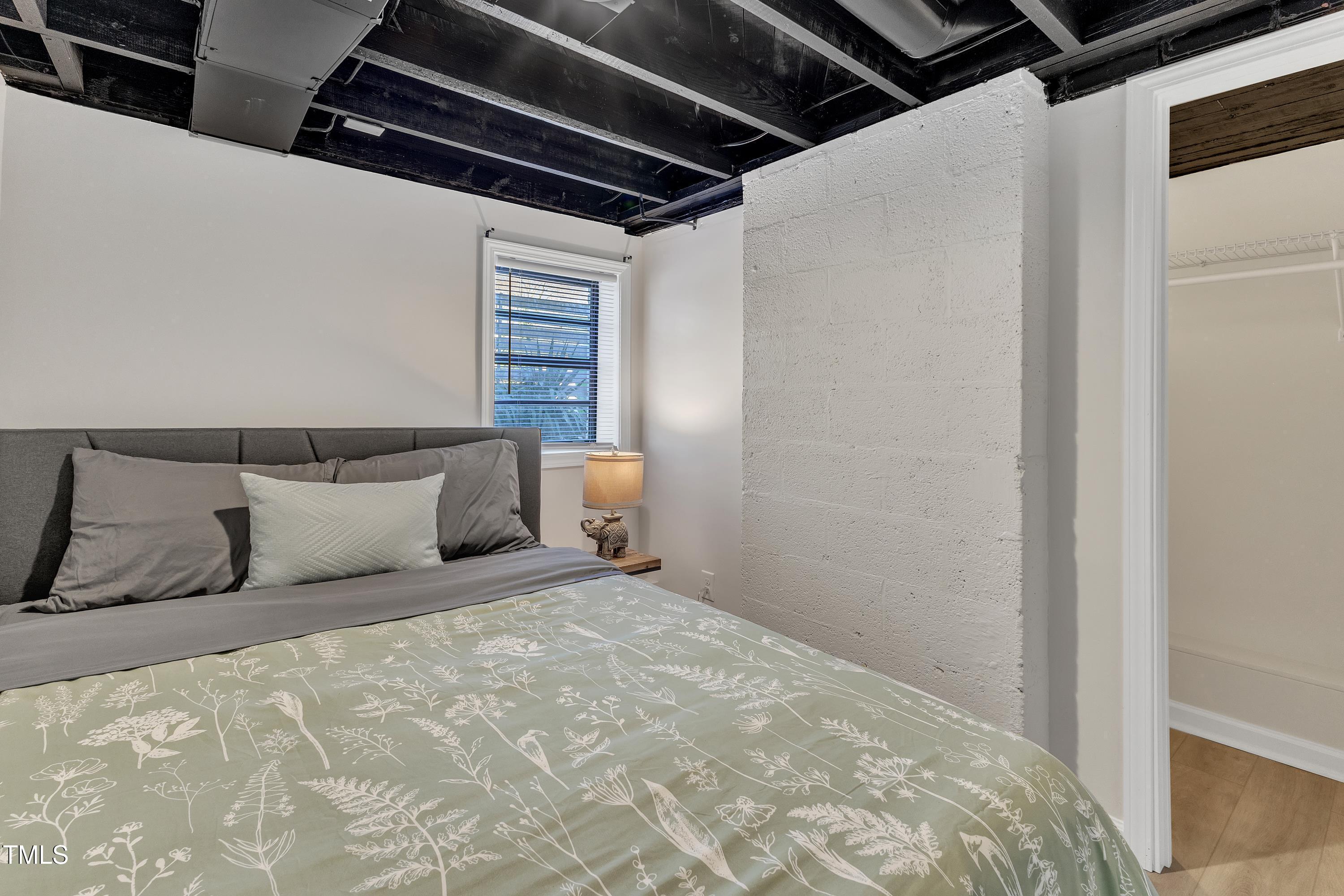 602 Quarry Street Raleigh, NC 27601 - Photo 29 of 49 a large bed sitting in a bedroom next to a window