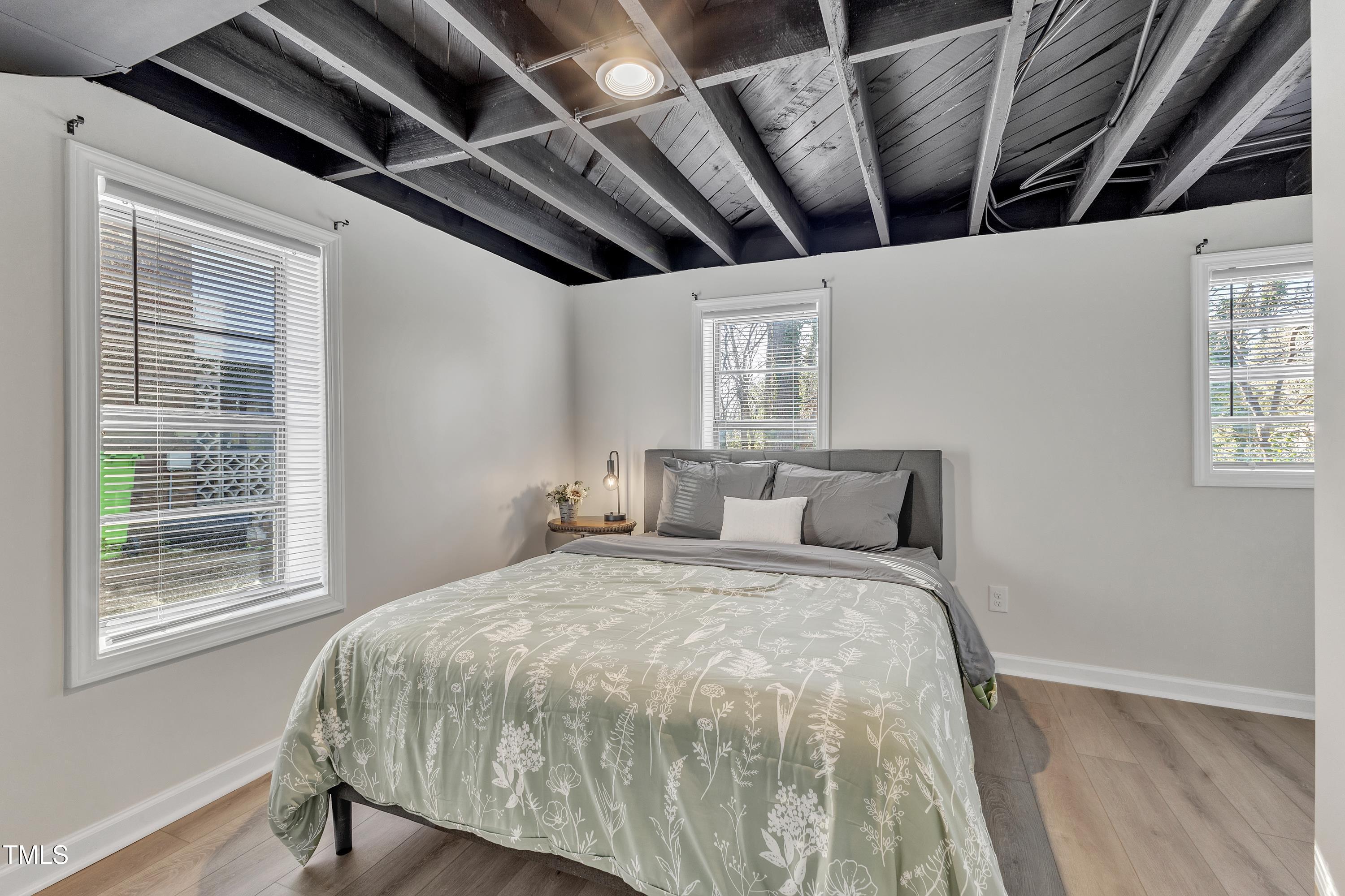 602 Quarry Street Raleigh, NC 27601 - Photo 32 of 49 a bed sitting in a bedroom next to a window