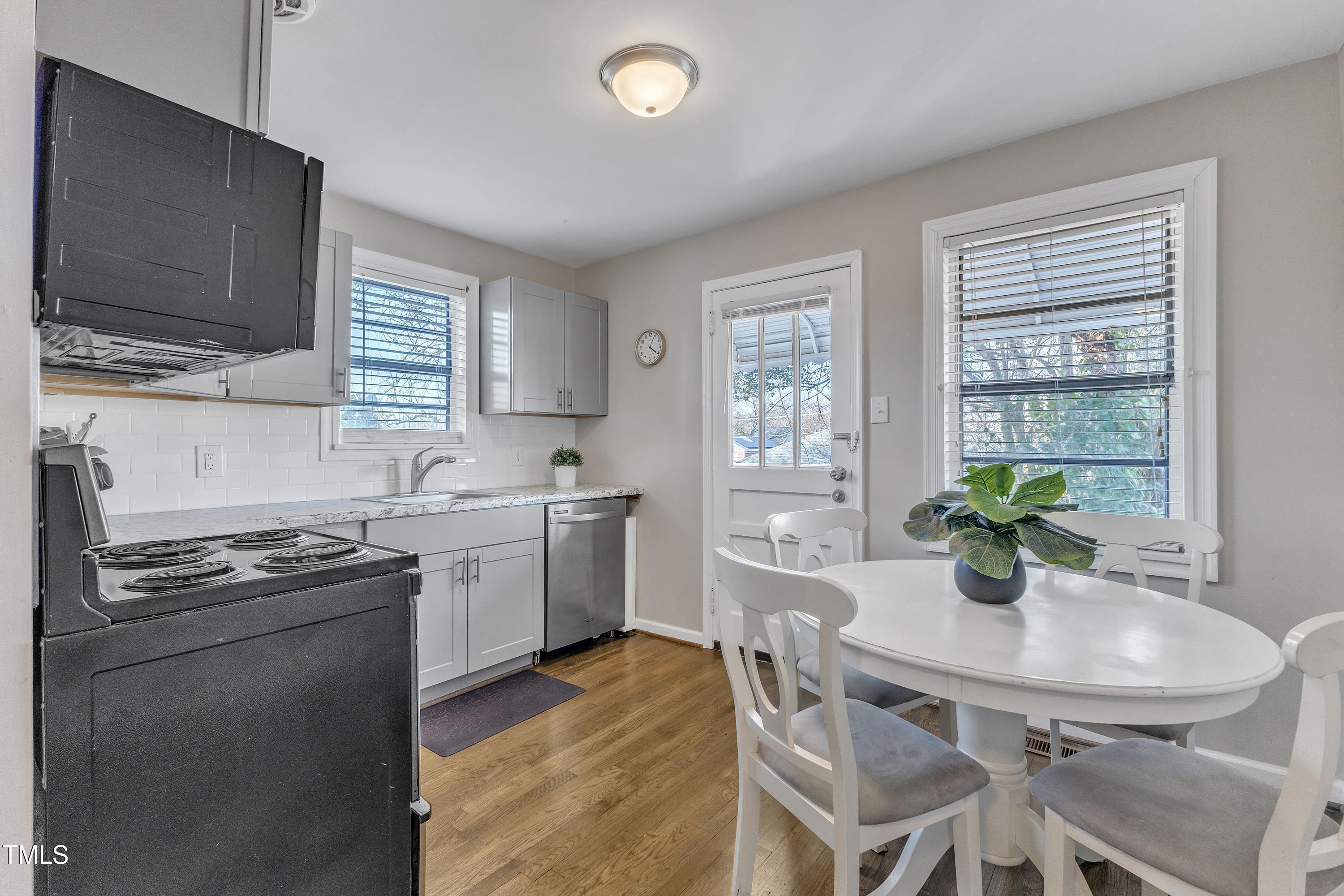 602 Quarry Street Raleigh, NC 27601 - Photo 10 of 49 a kitchen with stainless steel appliances granite countertop a sink a stove a dining table and chairs