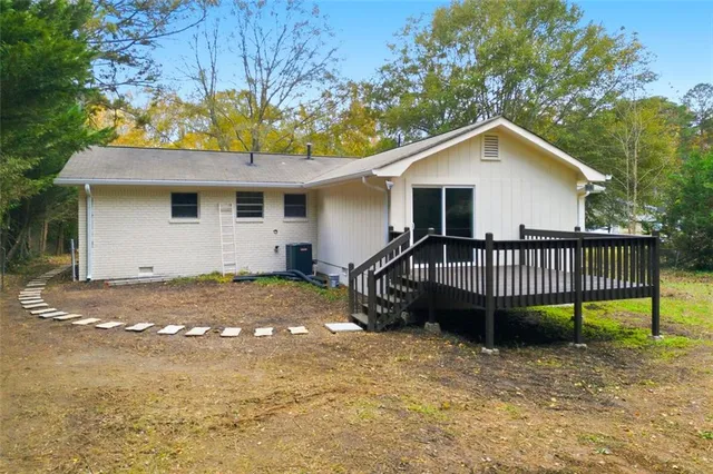 a view of a house with a yard and sitting area
