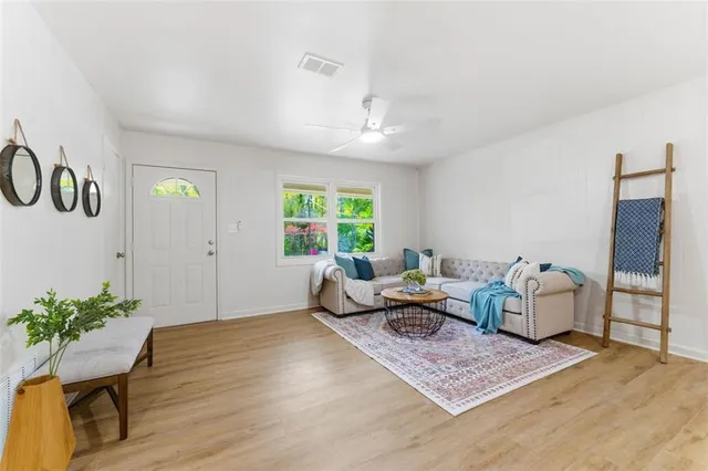 a living room with furniture and wooden floor