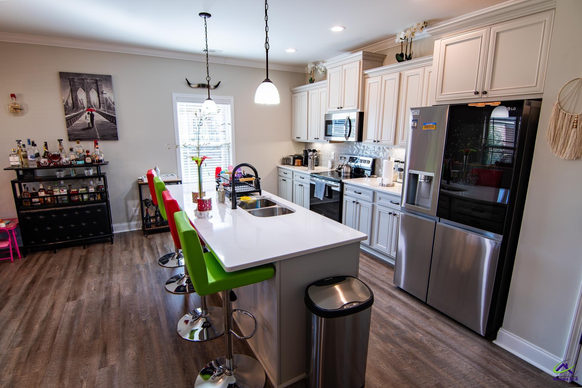 123 Logan's Mill Trail Warner Robins, GA 31093 - Photo 6 of 23 a kitchen with kitchen island a counter space a sink appliances and cabinets