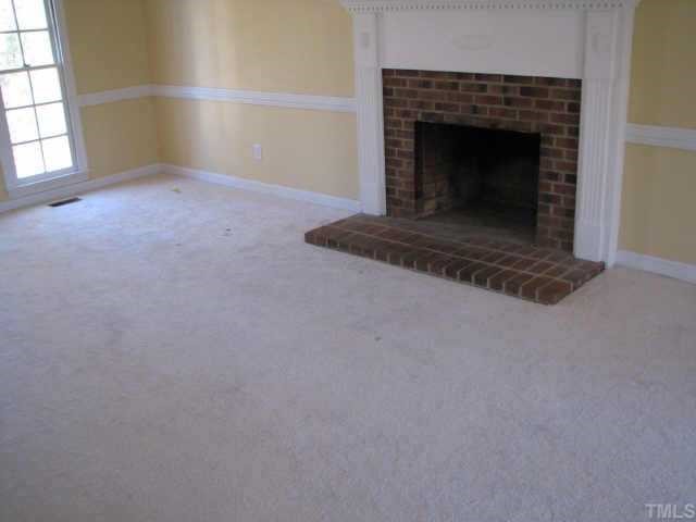 2417 Basil Drive Raleigh, NC 27612 - Photo 5 of 12 a view of empty room with a fireplace